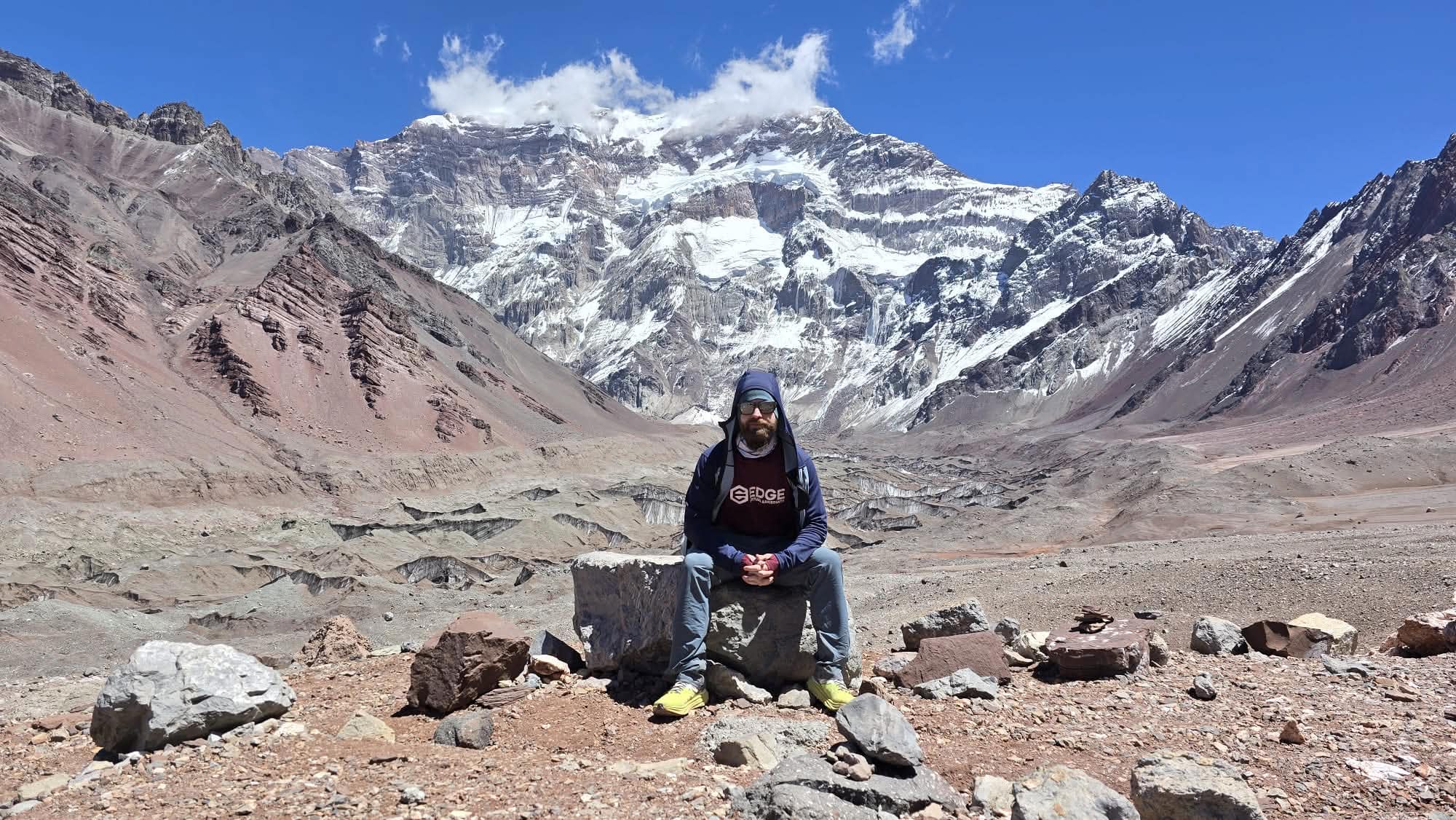 Cole Kline sitting in front of Mt. Aconcagua