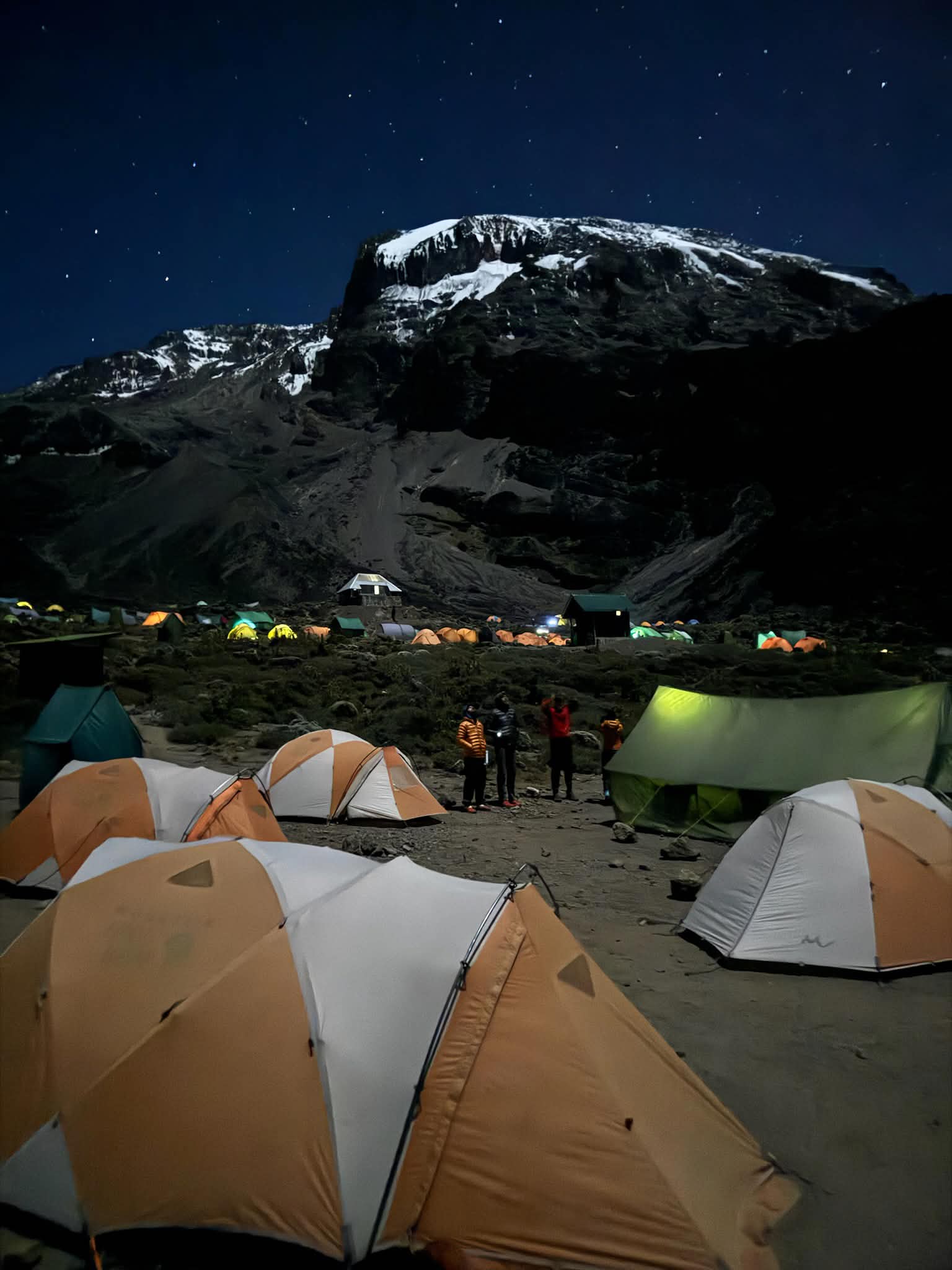 Off-grid mountain camp at night